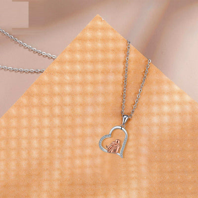 Heart-shaped pendant necklace on a textured beige surface