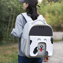 Person wearing a backpack with a cartoon dog design outdoors