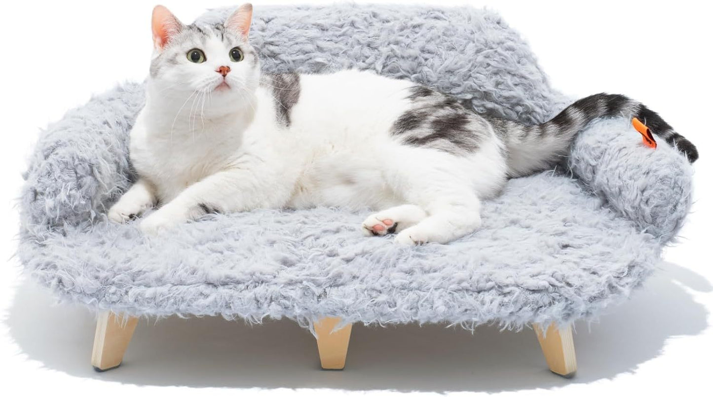 Cat lying on a fluffy gray pet bed with wooden legs against a white background