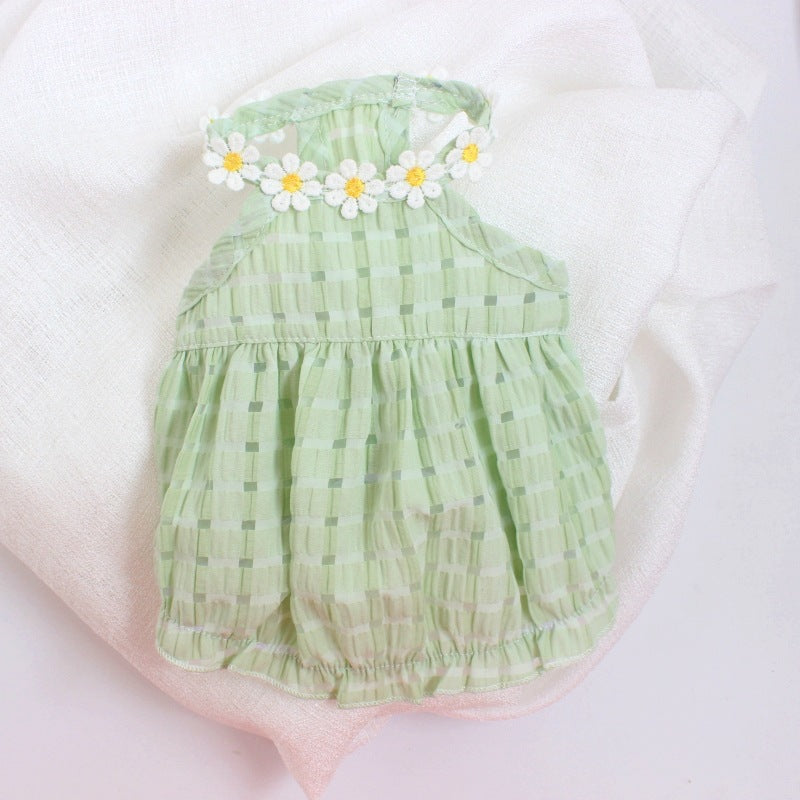 Green baby romper with floral headband on a white background