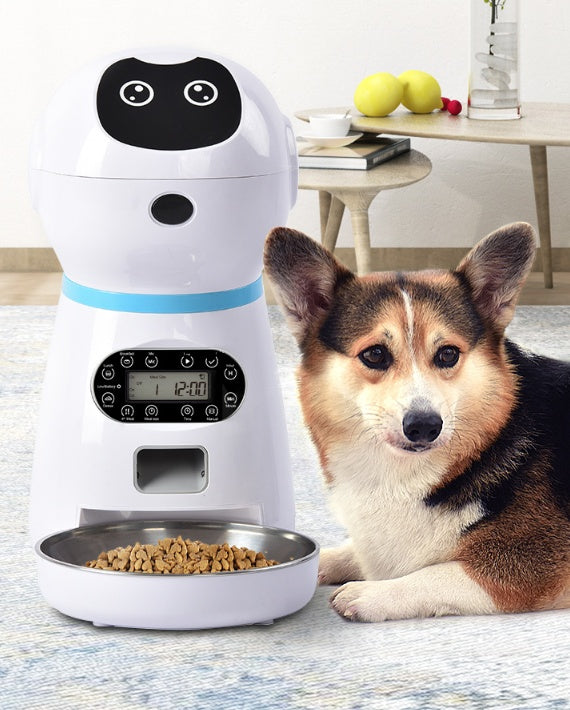 Dog next to a white pet feeder with a digital display in a home setting.