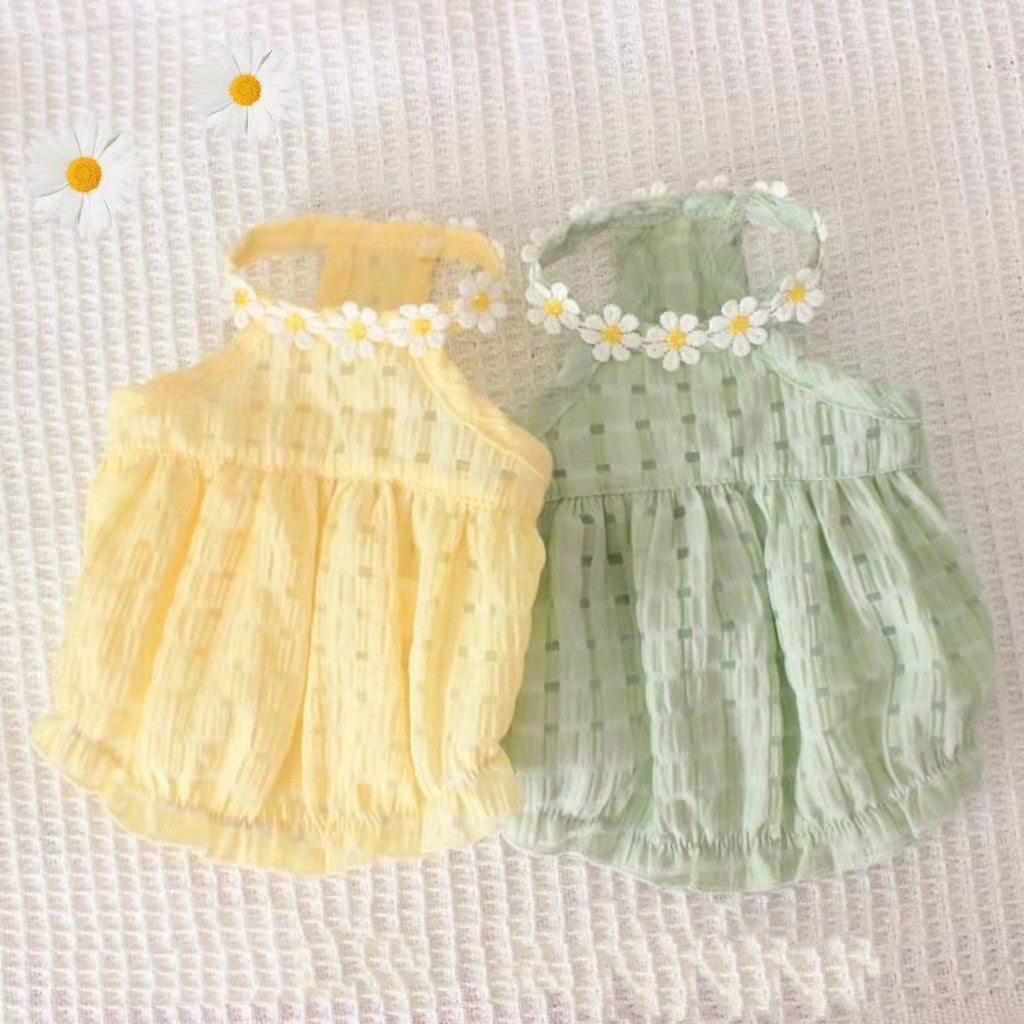 Two baby rompers, one yellow and one green, with floral headbands on a textured white background.