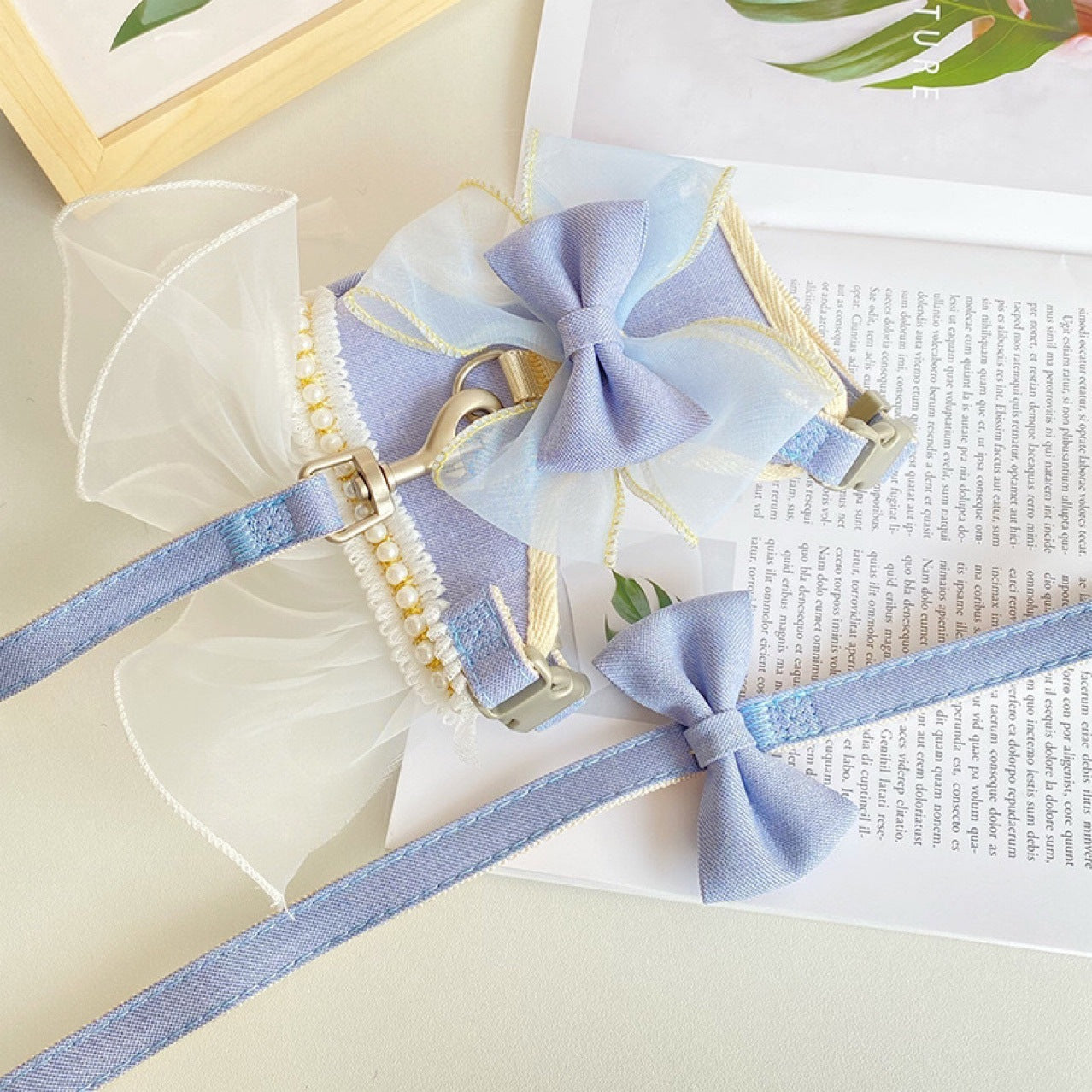 Light blue dog harness with bow tie on a white surface