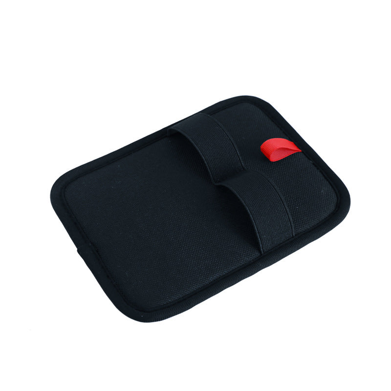 Black mouse pad with a red button on a white background