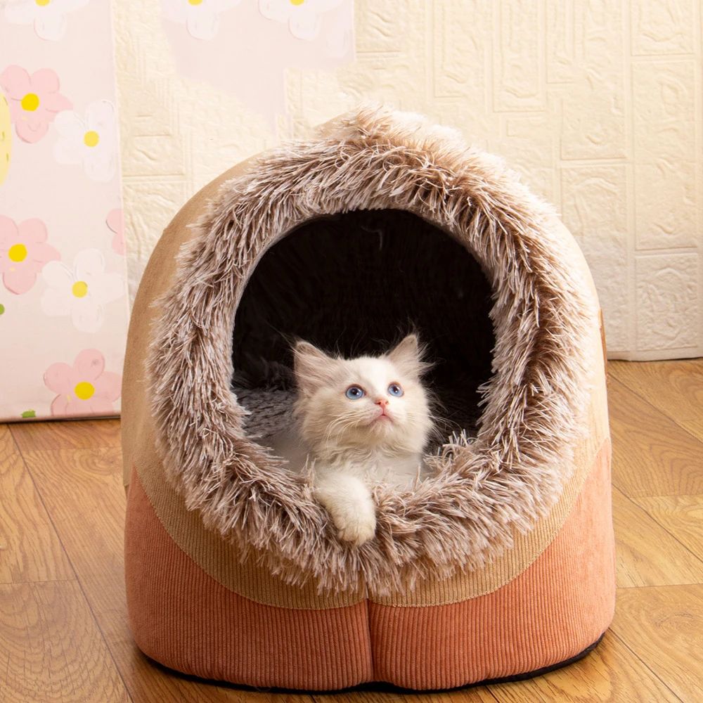 Cat sitting inside a cozy pet bed on a wooden floor.
