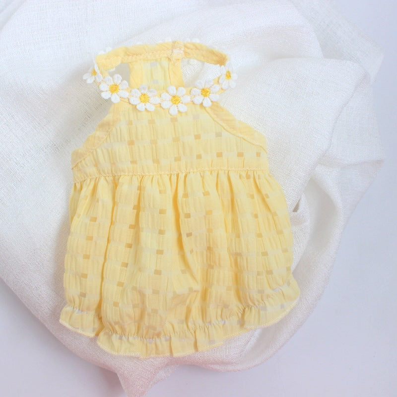 Yellow baby romper with floral details on a white background