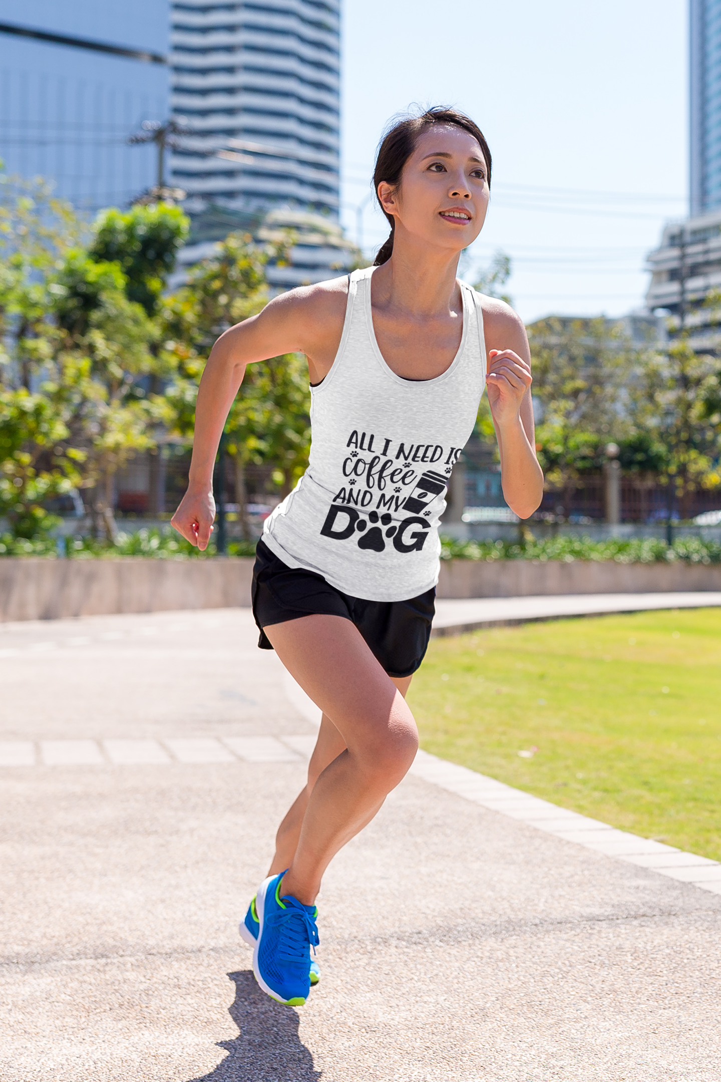 Woman running outdoors wearing Coffee Dog Lover's Racerback Tank with coffee and dog graphic