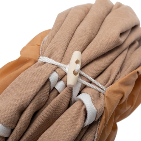 Folded beige Cozy Pet Tunnel Bed by Wefulfil secured with white cord and plastic toggle
