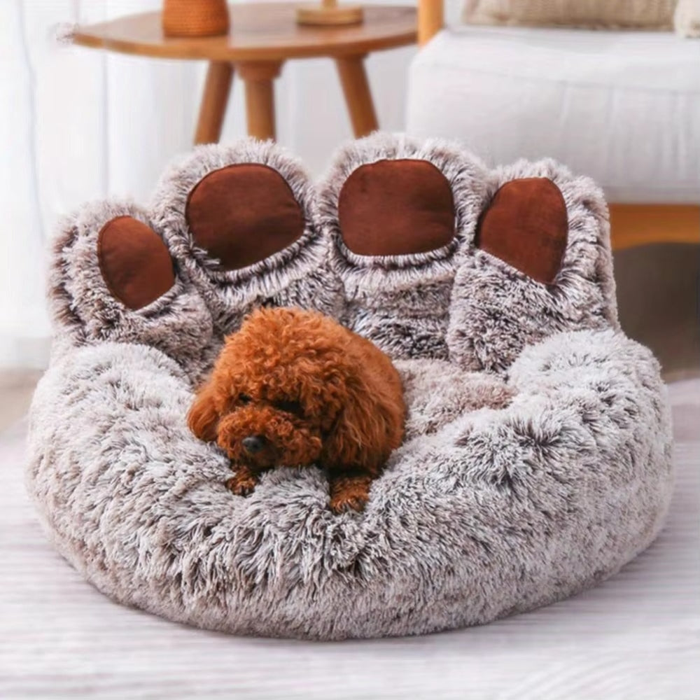Purrfect Pet Haven paw-shaped pet bed in plush gray with brown paw pads holding a small brown poodle