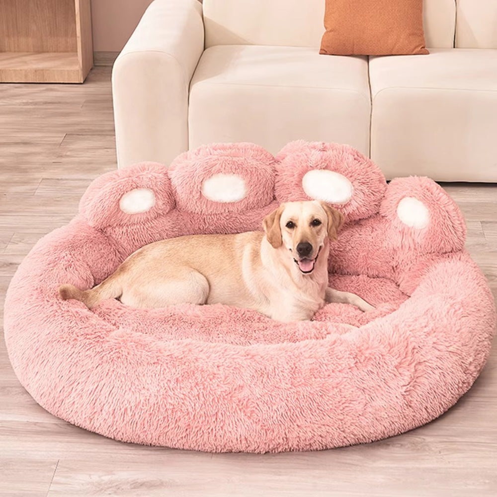 Purrfect Pet Haven pink fluffy paw-shaped pet bed with Labrador resting on plush floor cushion in living room