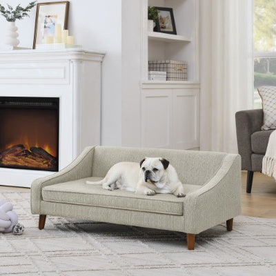 Wefulfil Dog Sofa Bed in beige fabric with mid century wooden legs and bolstered sides by fireplace
