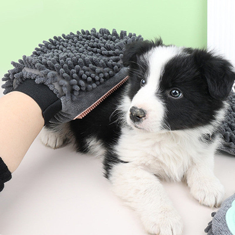 Wefulfil Dog and Cat Grooming Glove in gray with soft bristles used to groom a black and white puppy