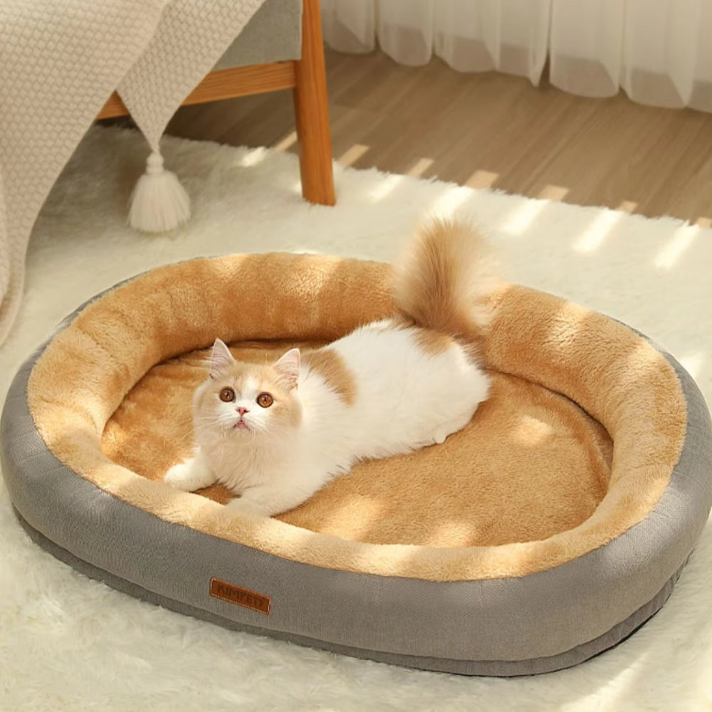 Purrfect Pet Haven Plush Oval Pet Bed in gray and tan with fluffy cat lounging on cozy indoor cushion