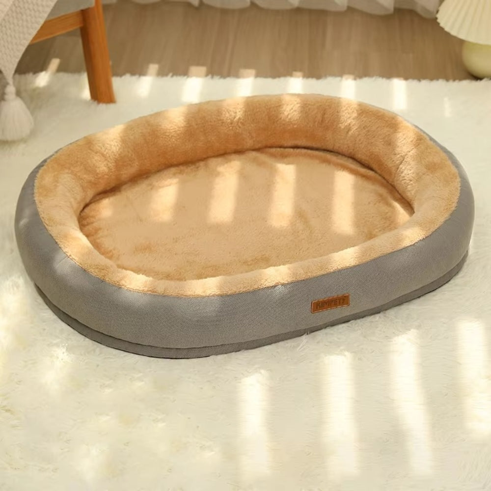 Purrfect Pet Haven Plush Oval Pet Bed with bolstered rim and tan plush interior on rug