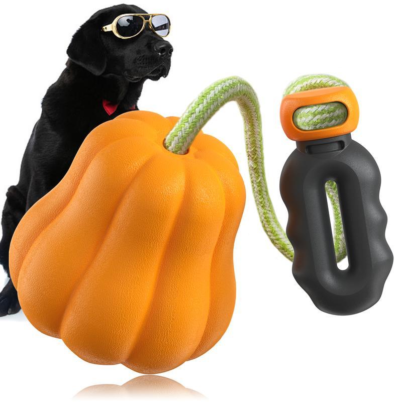 Wefulfil indestructible dog rope toy orange pumpkin float chew toy with green rope and black handle beside black labrador