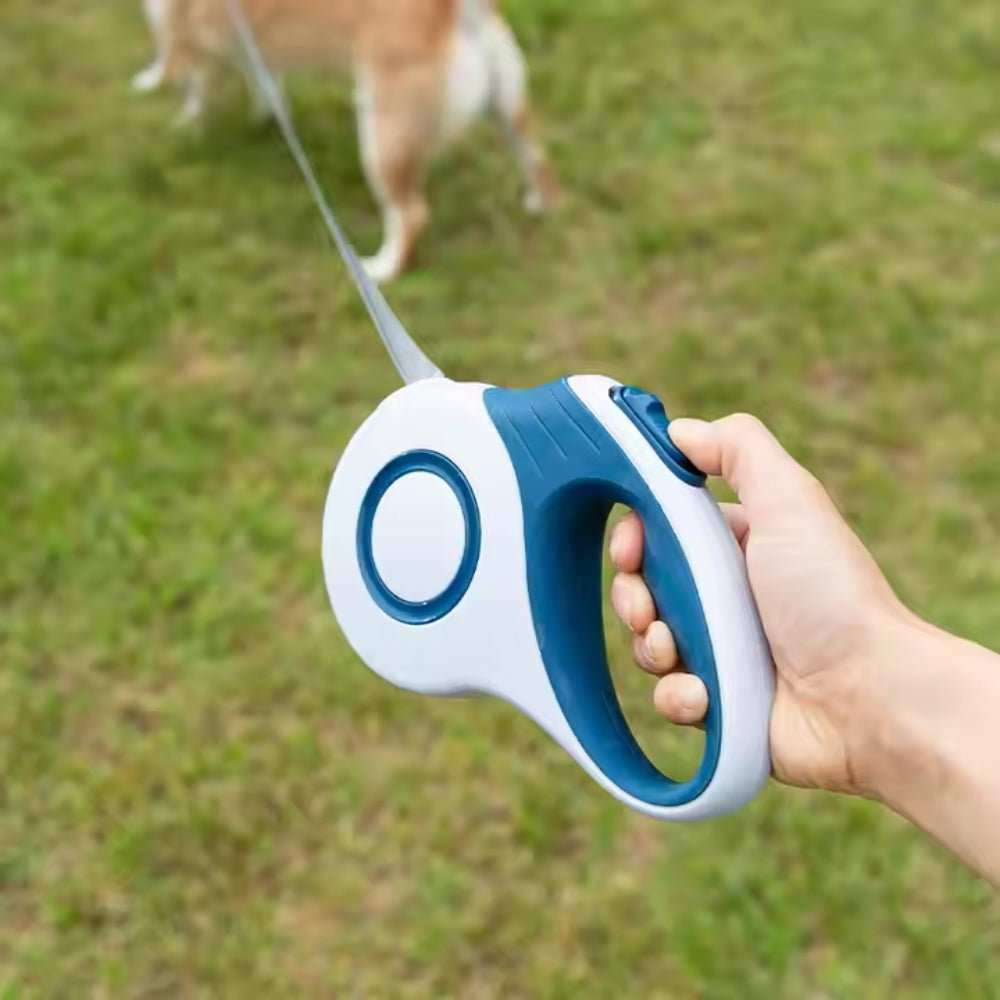 Purrfect Pet Haven Retractable Dog Leash white and blue handheld leash with ergonomic grip dog on grass
