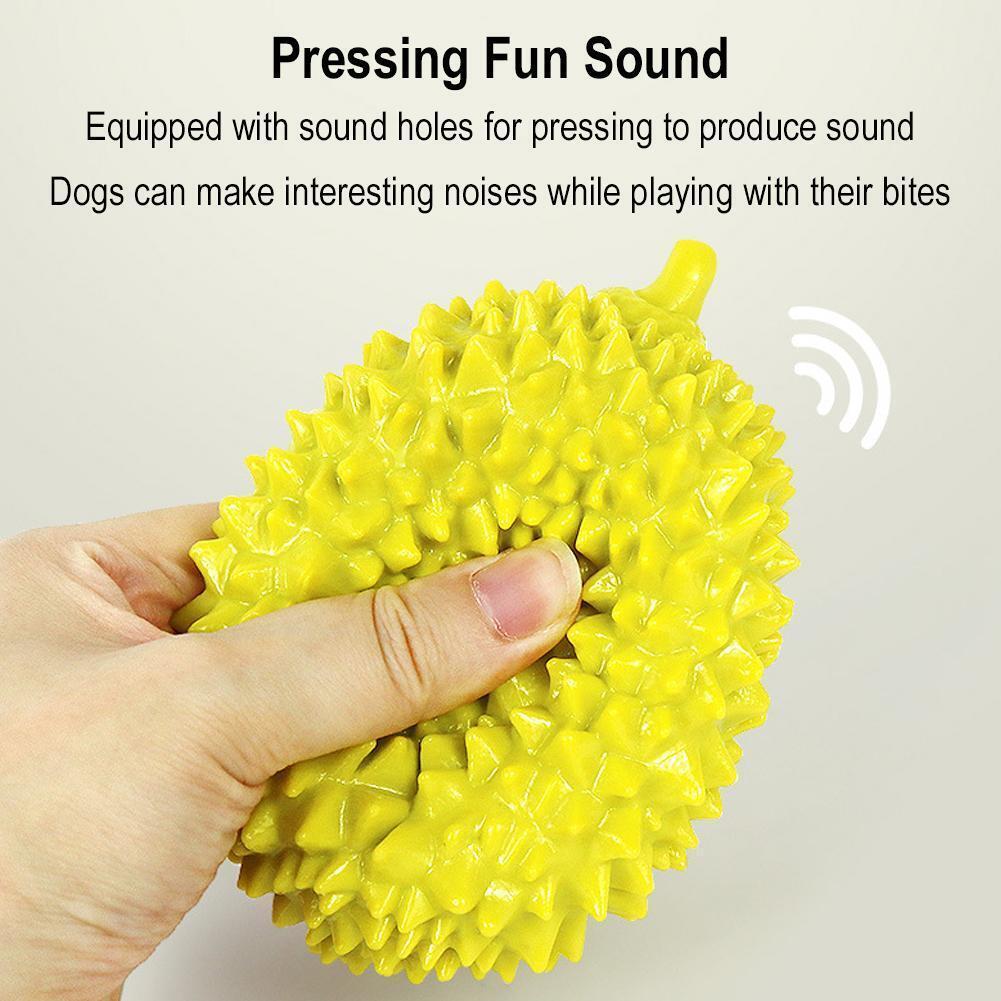Wefulfil yellow durian shaped dog chew toy being squeezed by hand textured spiky squeaky chew for dogs