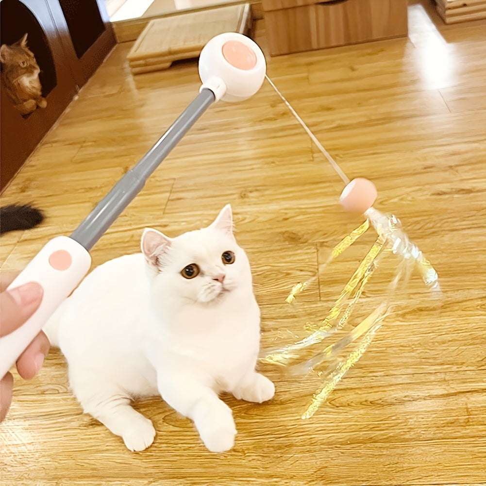 Wefulfil retractable cat wand toy with sparkly tinsel lure being used to play with white cat on wood floor