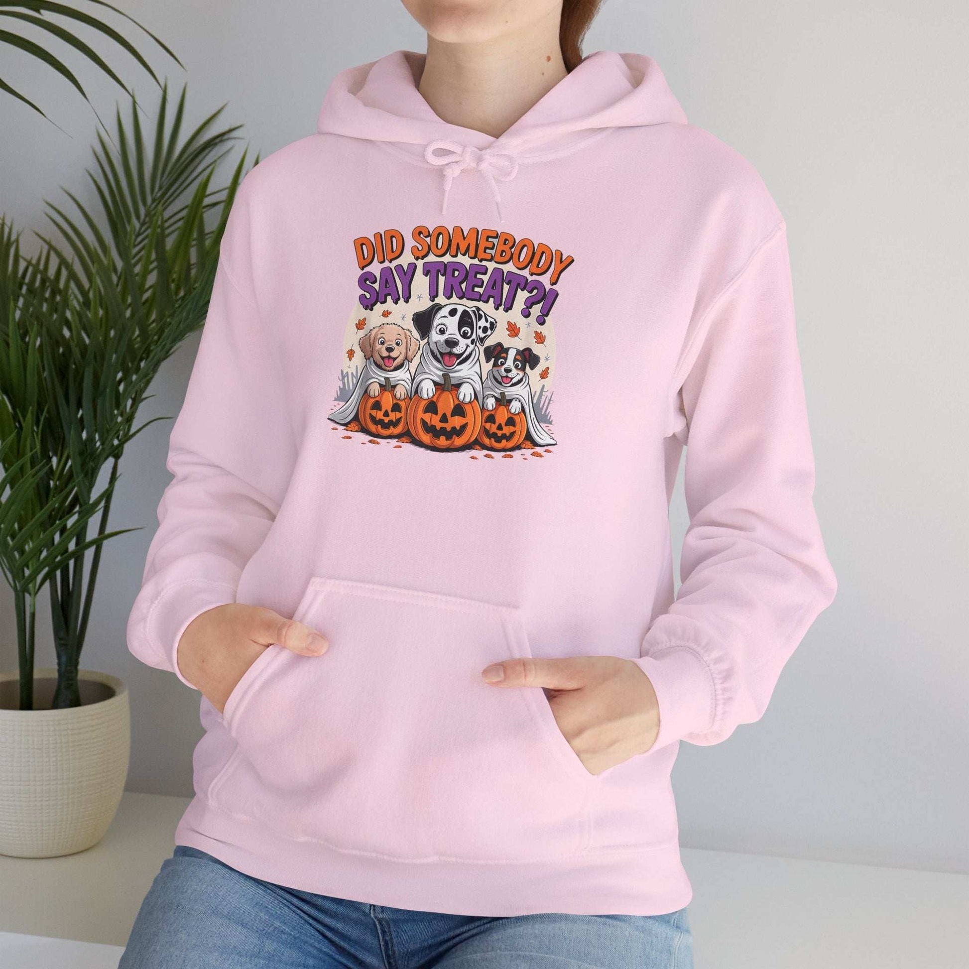 Printify pink hoodie featuring Halloween Dog Sweatshirt design with three dogs, pumpkins and Did Somebody Say Treat text