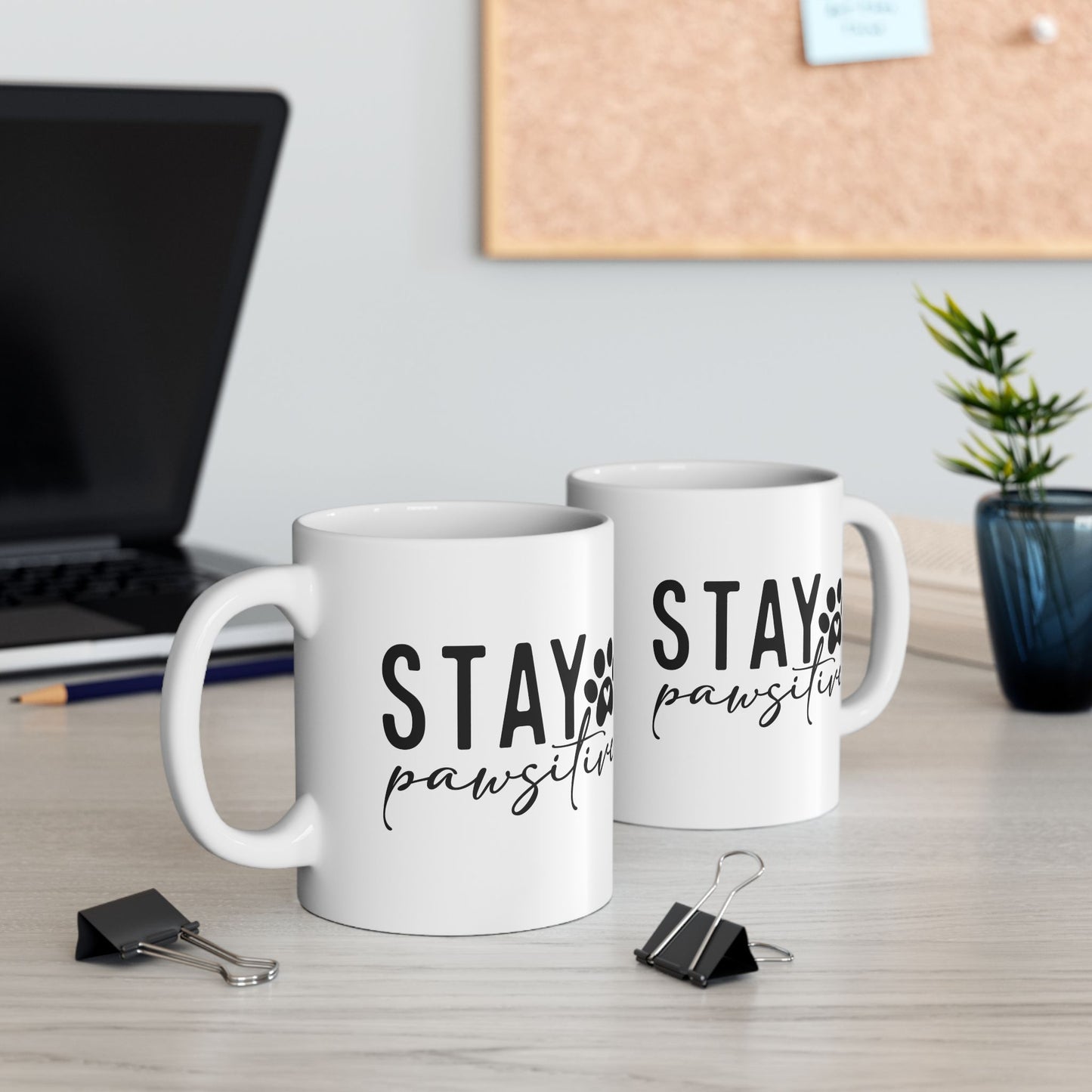 Printify Stay Pawsitive Mug white ceramic coffee cup with black text on office desk