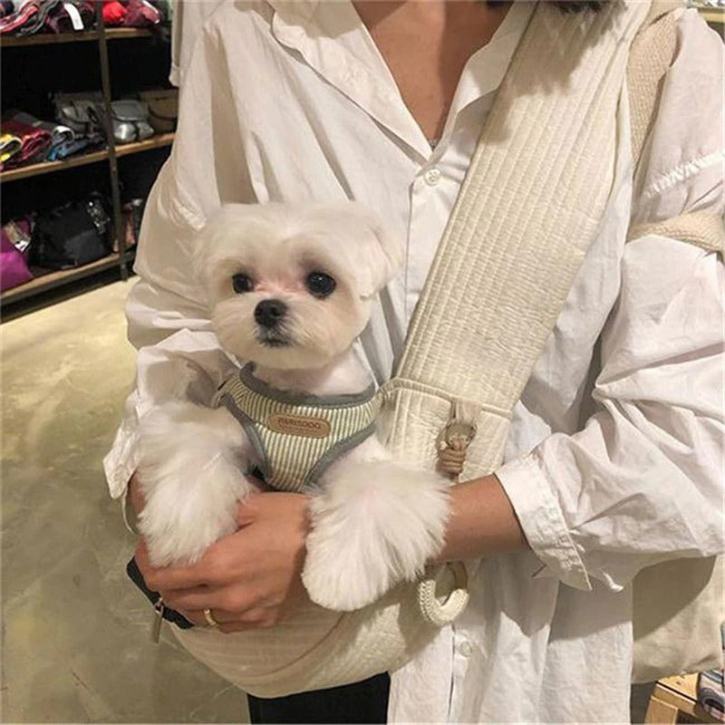 Wefulfil Cozy Pet Sling Carrier in beige holding a small white dog with a striped harness