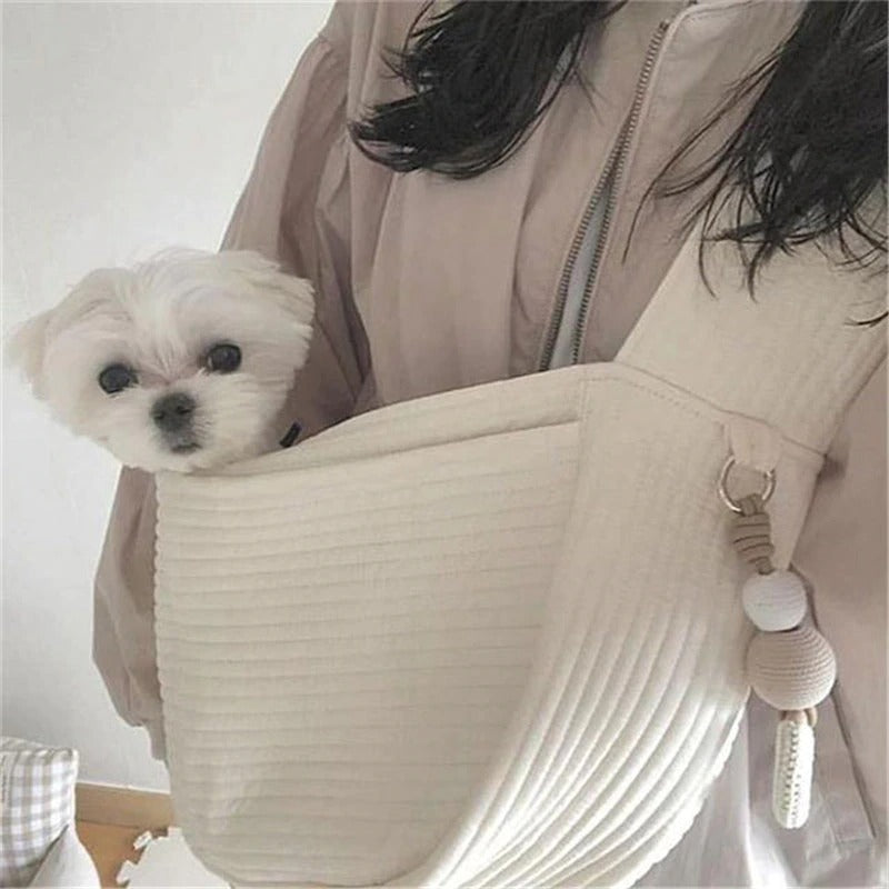 Wefulfil Cozy Pet Sling Carrier in beige with small white dog inside for hands-free pet carrying