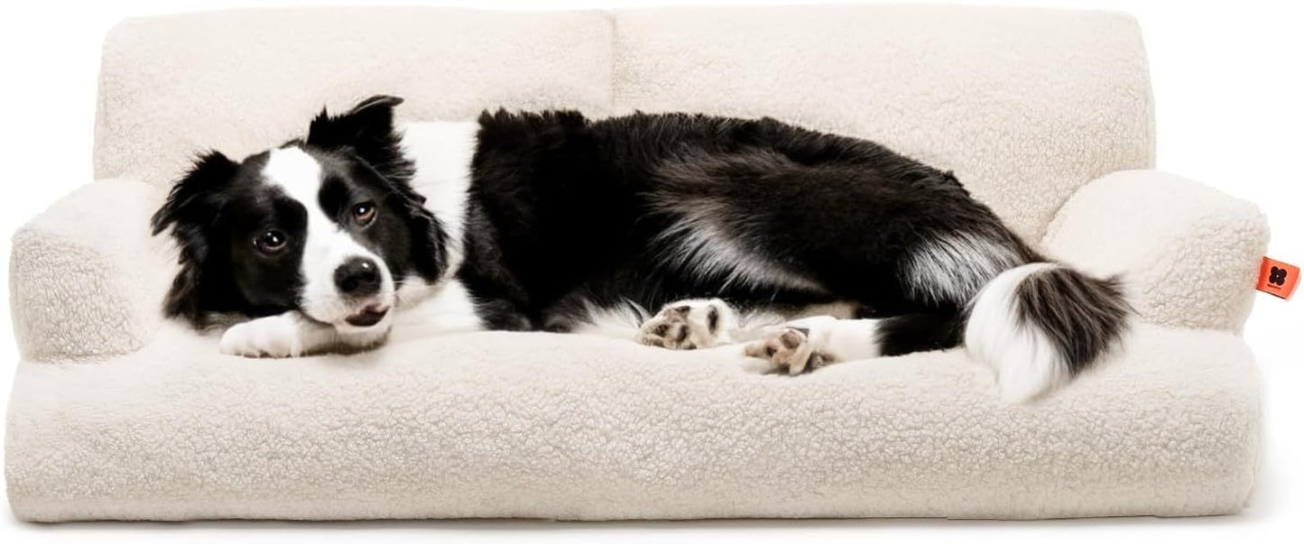 Black and white dog lying comfortably on a cream-colored Waterproof Pet Bed from Printify