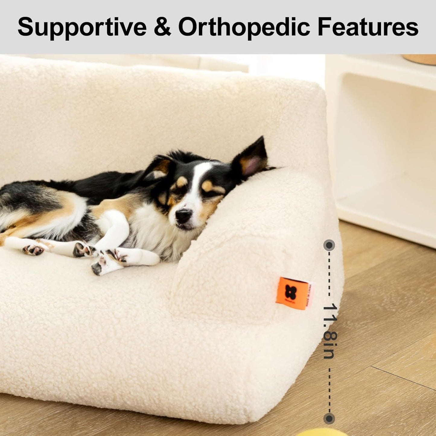 Small black and white dog resting on a supportive orthopedic waterproof pet bed by Printify