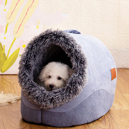 Dog peeking out from a gray pet bed with a fluffy interior on a wooden floor.