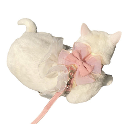 White cat-shaped toy with a pink bow and leash on a white background