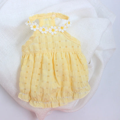 Yellow baby romper with floral details on a white background