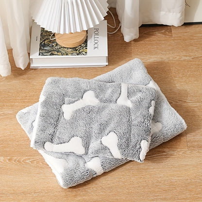 Wefulfil grey plush self-warming cat bed mat with white bone pattern folded on wooden floor near lamp