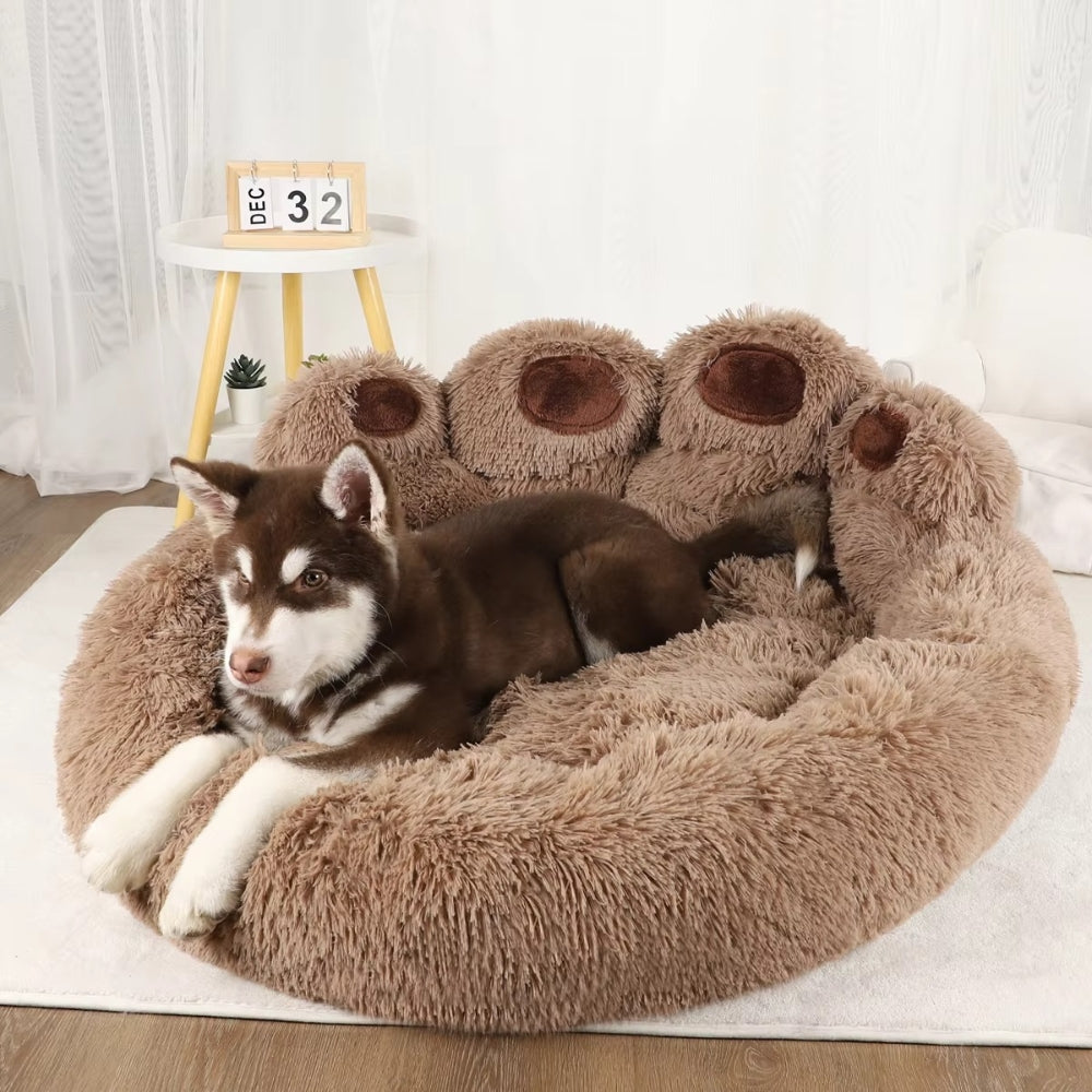 Purrfect Pet Haven paw-shaped pet bed in plush brown with raised paw pads and husky puppy resting