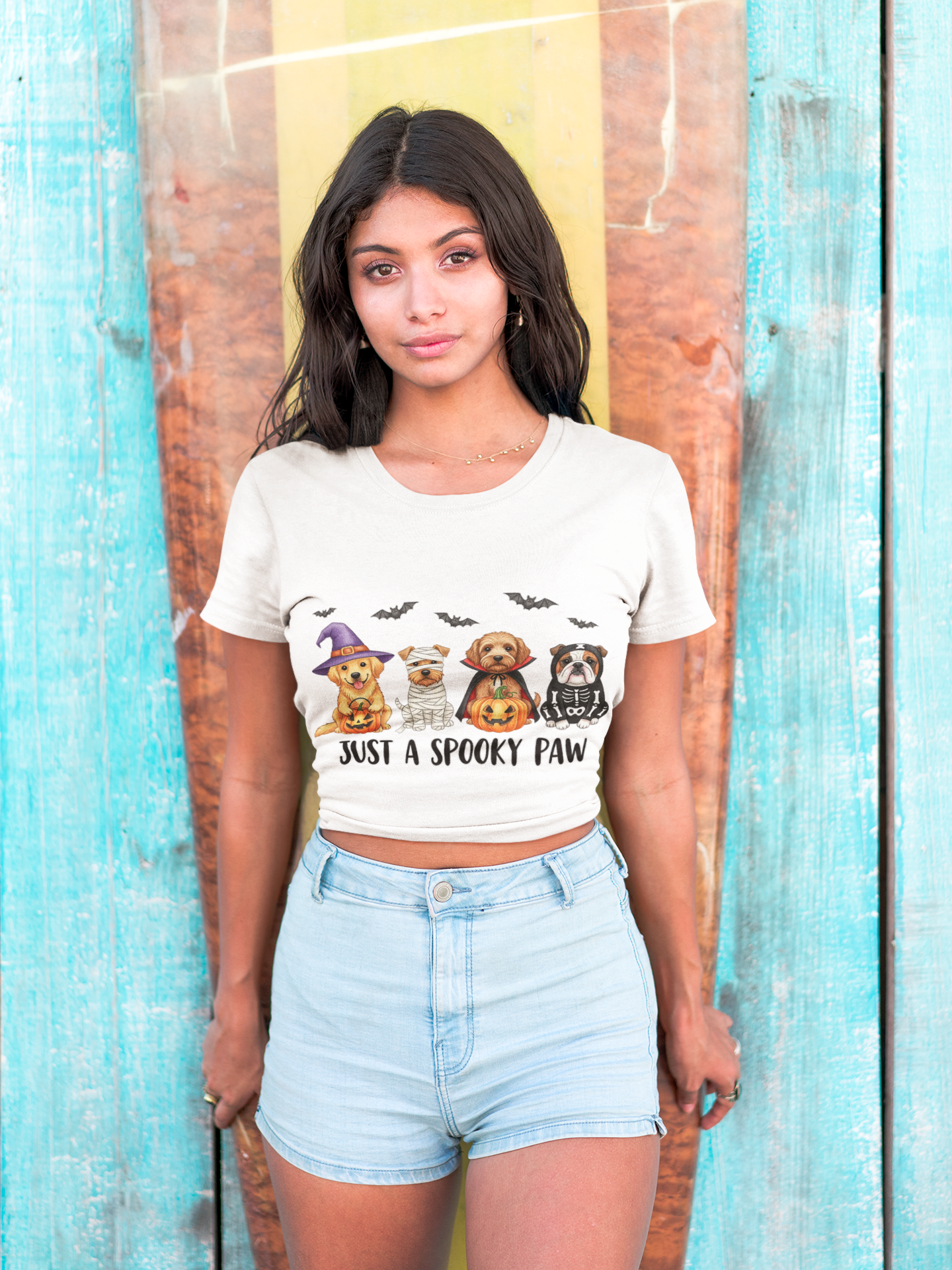 Printify model wearing Spooky Pet Shirt white cropped tee with four Halloween dogs and bats