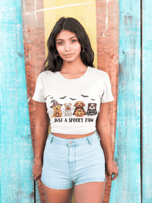 Printify model wearing Spooky Pet Shirt white cropped tee with four Halloween dogs and bats