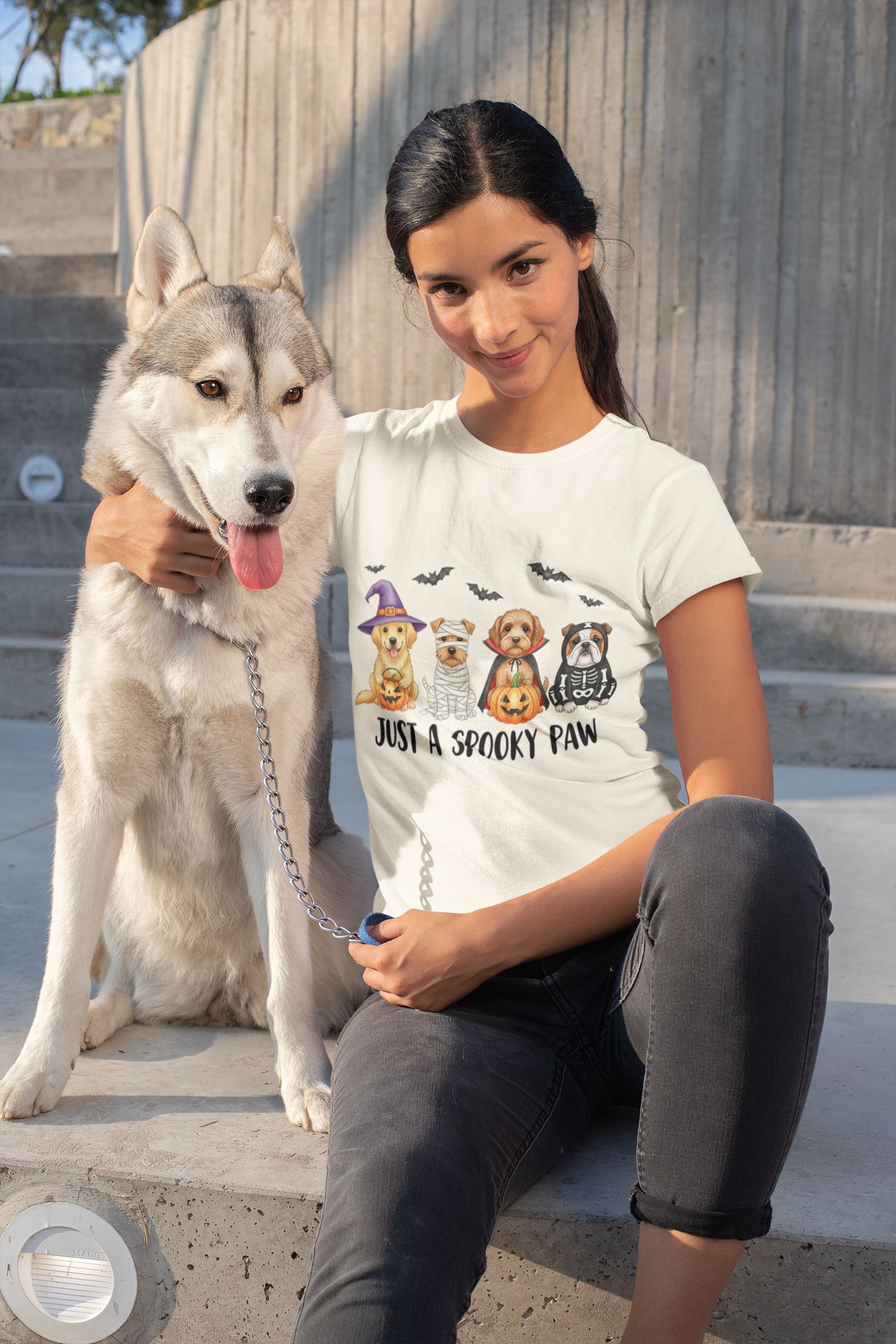 Printify Spooky Pet Shirt white t shirt with Halloween dog trio design worn by woman holding husky on steps