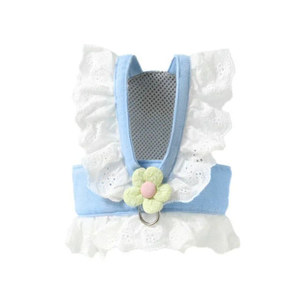 Pet harness with white lace, blue straps, and a floral design on a white background