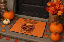 Front door with Make Halloween Great Again Trump pumpkin floor mat