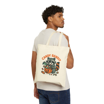 Printify Canvas Tote Bag with Candy Bandit raccoon Halloween design held over shoulder by model