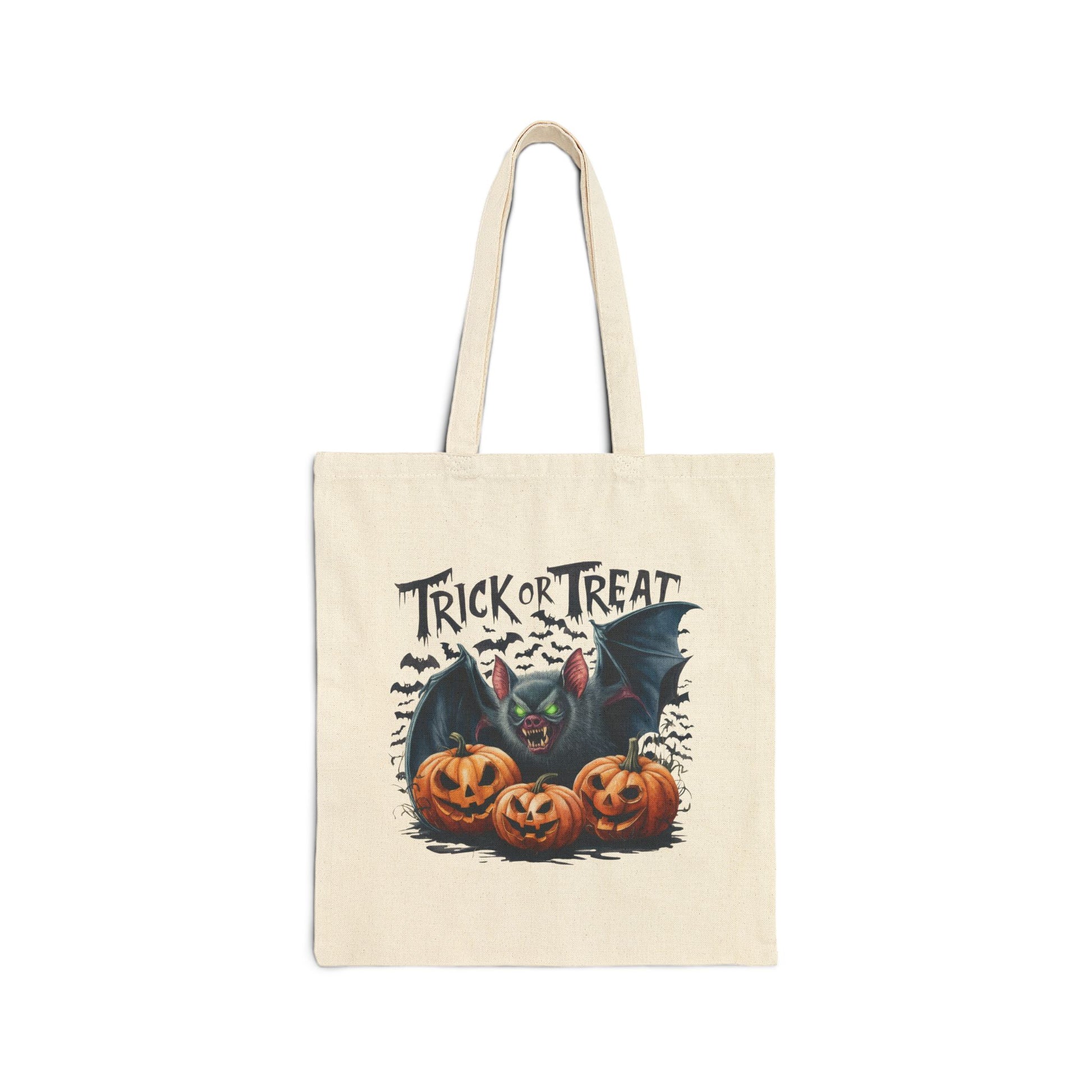 Printify Canvas Tote Bag with Halloween Trick or Treat design featuring a bat with green eyes and three jack o lanterns