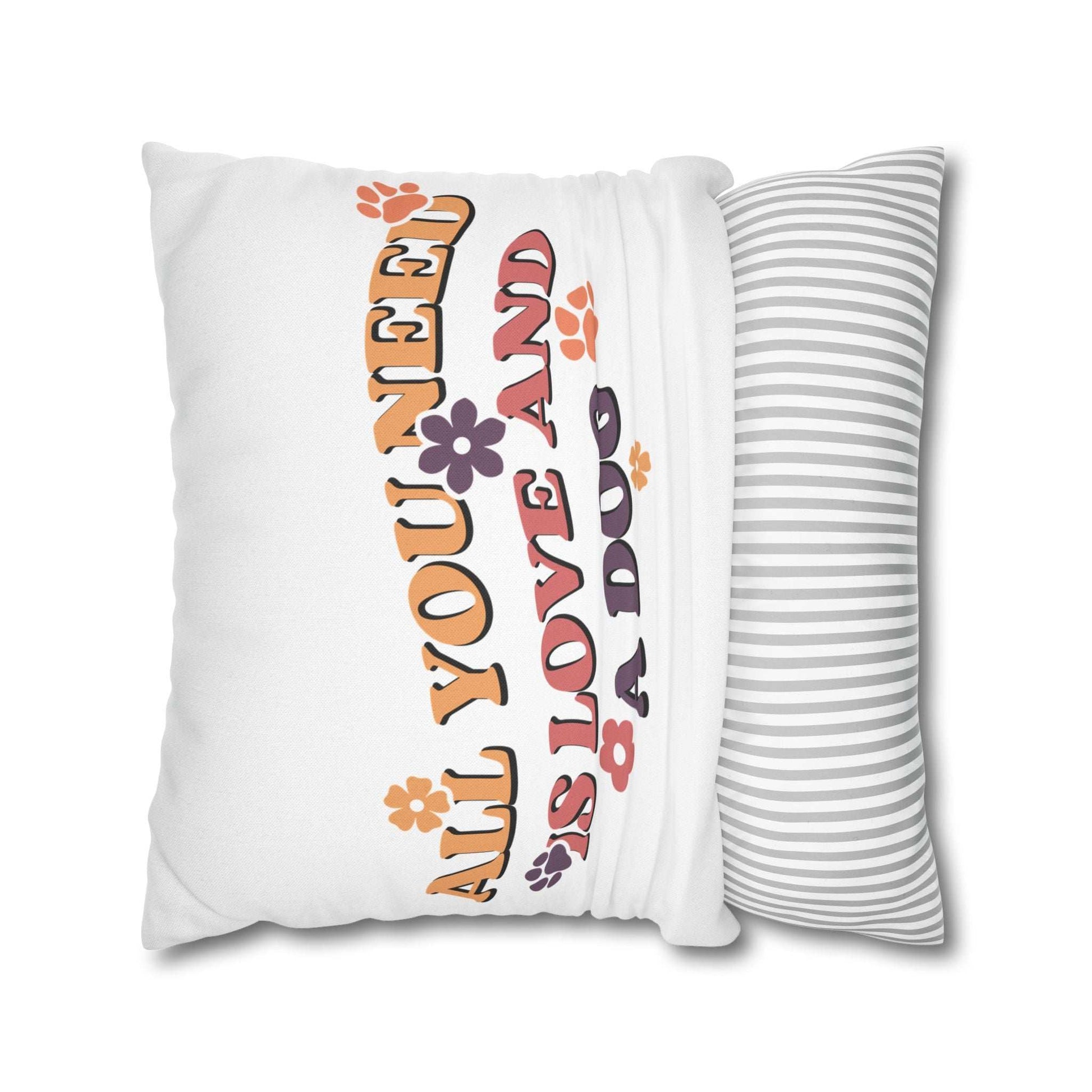 Cozy Throw Pillow with retro floral All You Need Is Love and a Dog design on white cover and gray striped back