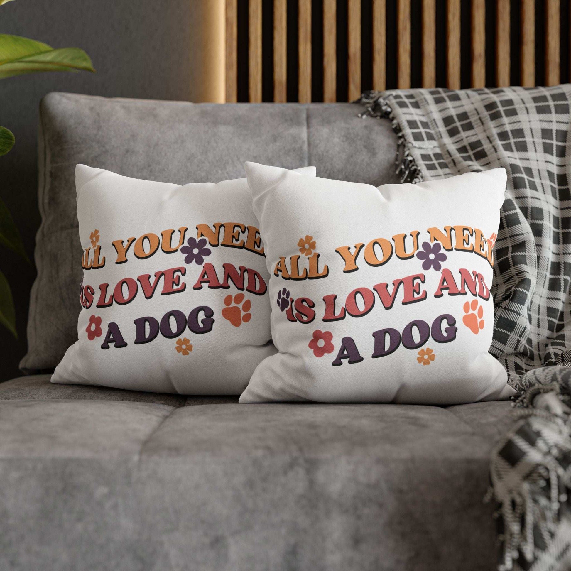 Cozy Throw Pillow pair with retro All You Need Is Love And A Dog print paw prints and flowers on gray sofa