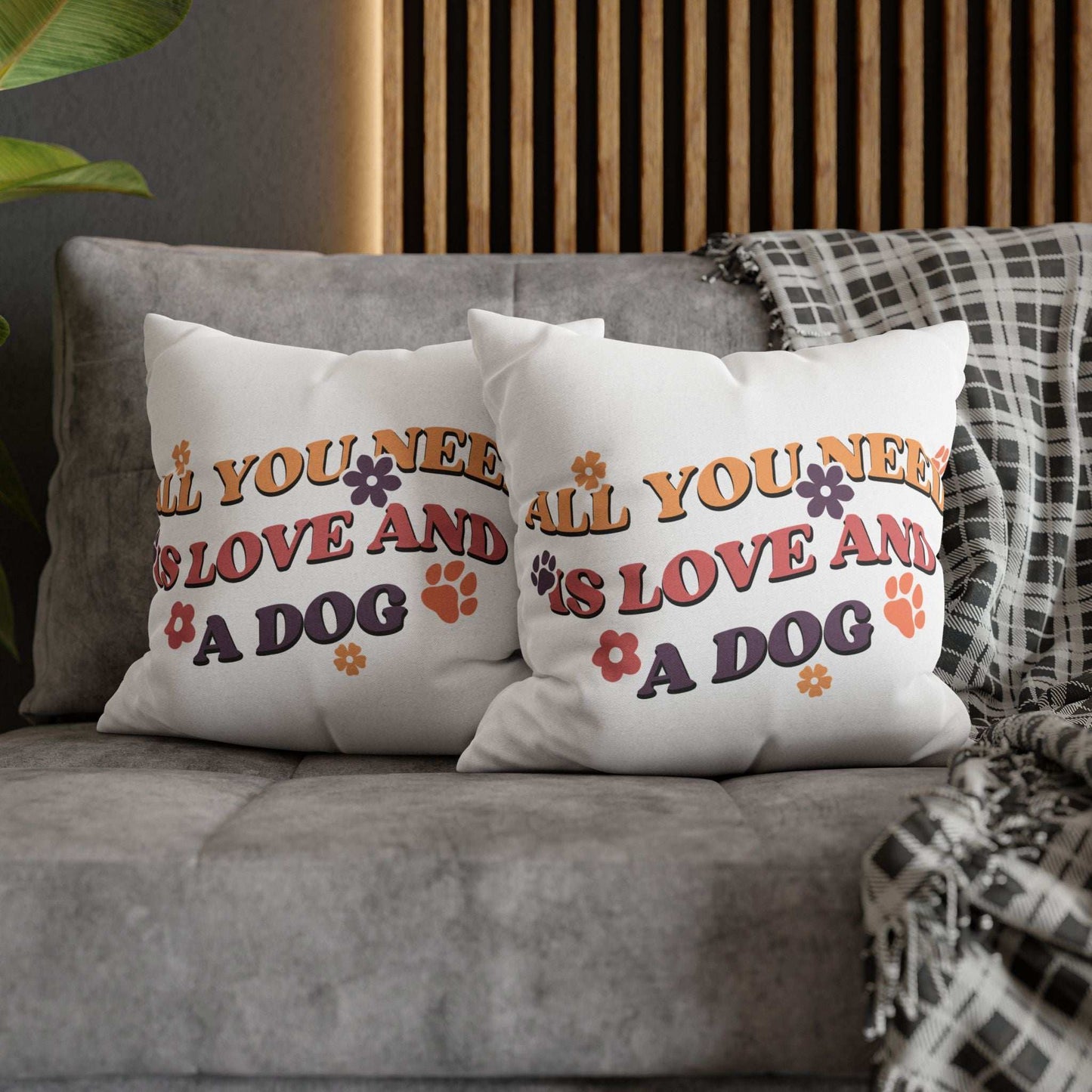 Cozy Throw Pillow pair on gray sofa featuring retro All You Need Is Love And A Dog print with paw prints and flowers