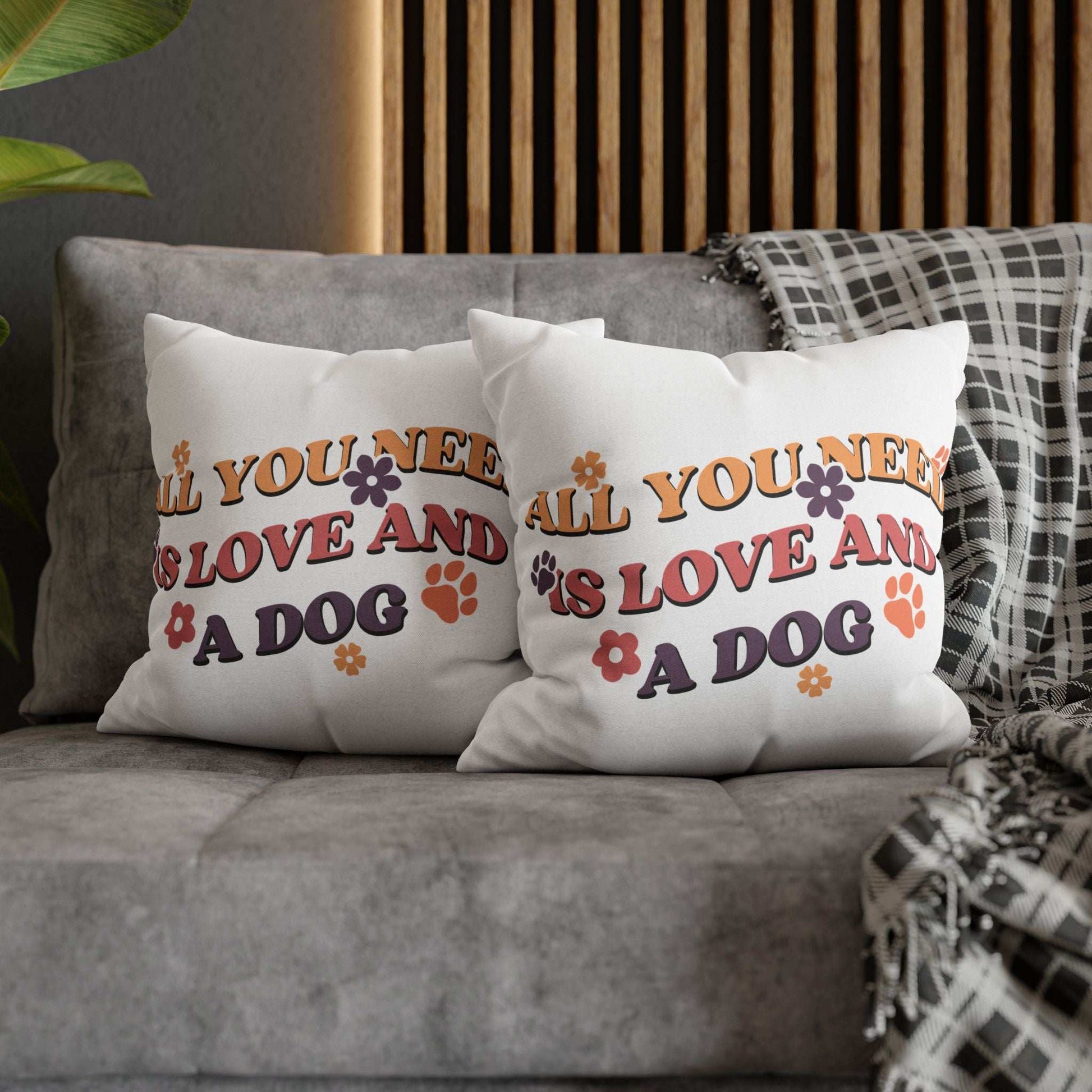 Cozy Throw Pillow pair on gray sofa featuring retro All You Need Is Love And A Dog print with paw prints and flowers