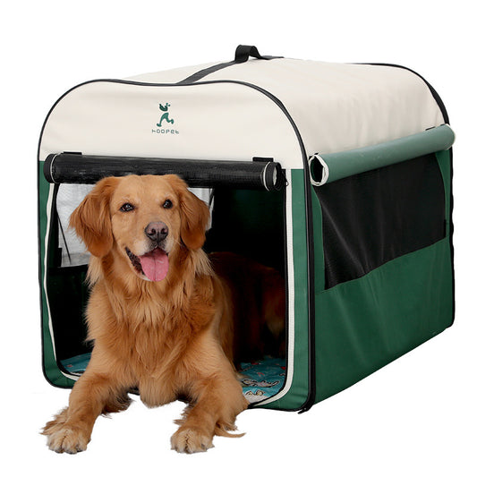 Golden retriever resting in green and cream large dog kennel house with mesh windows and roll up front door