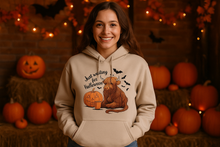 Woman in Highland Cow Halloween Hoodie with Autumn Decorations