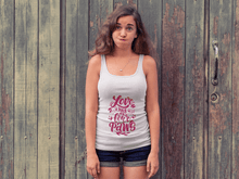 Printify white tank top with Love Has Four Paws graphic worn by woman standing in front of wooden doors