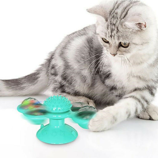 Wefulfil Massager Cat Toy in turquoise with rotating spiky design being played with by a gray and white cat