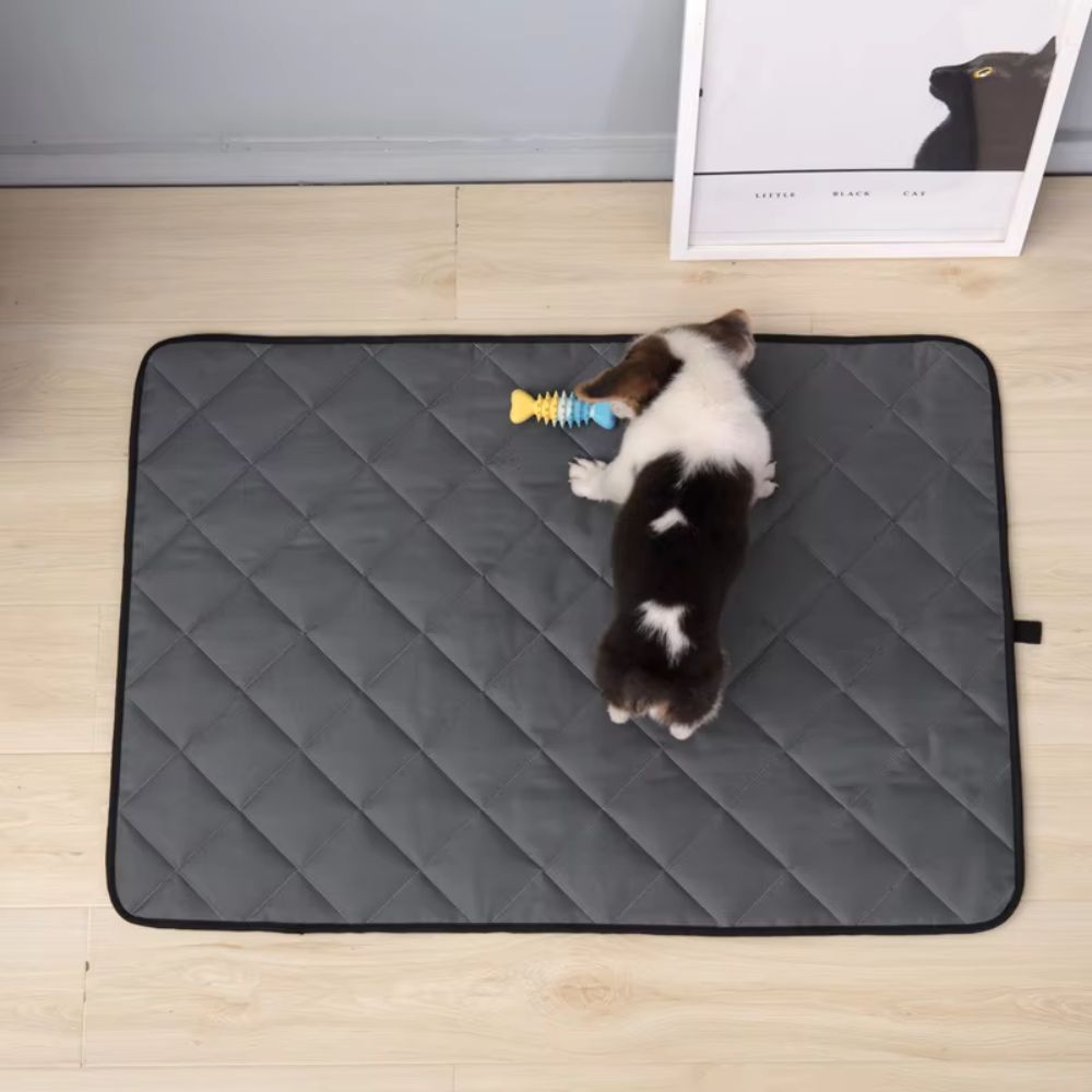 Purrfect Pet Haven Self Heating Pet Pad gray quilted mat with puppy and toy on hardwood floor