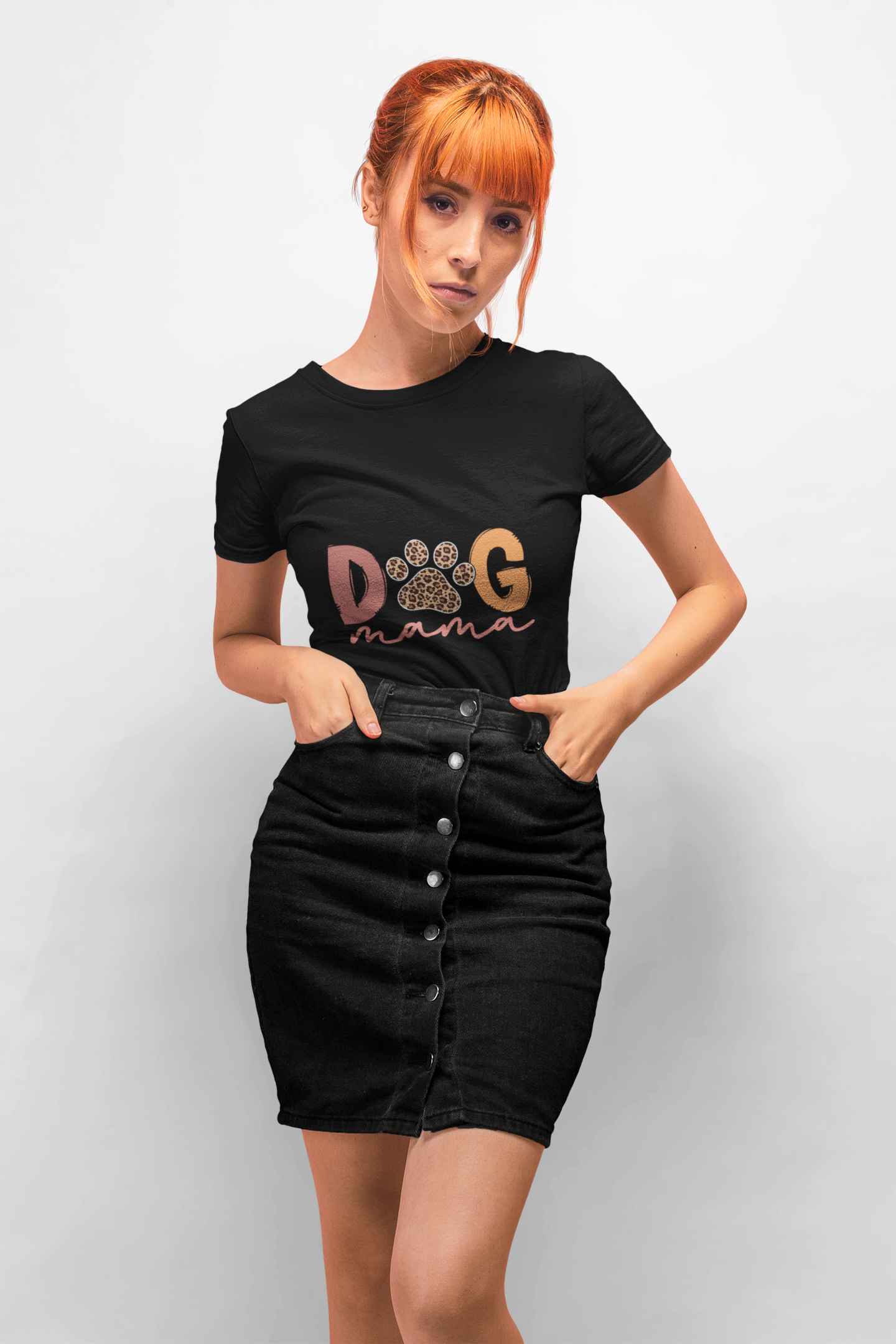 Red haired woman wearing a black Dog Mama Tee with paw design styled with a button front black denim skirt